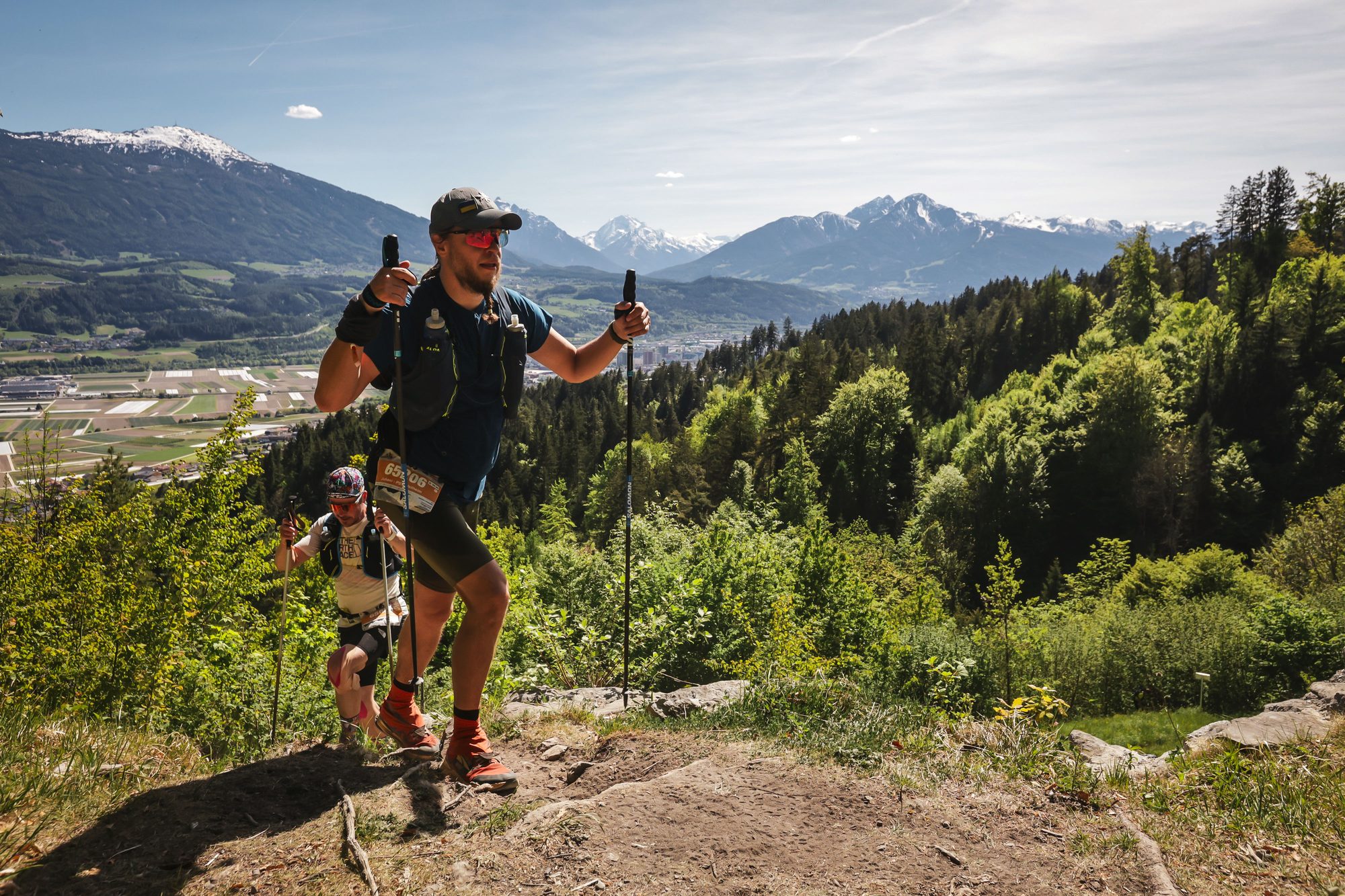 Juhani on a mountain trail, valley behind