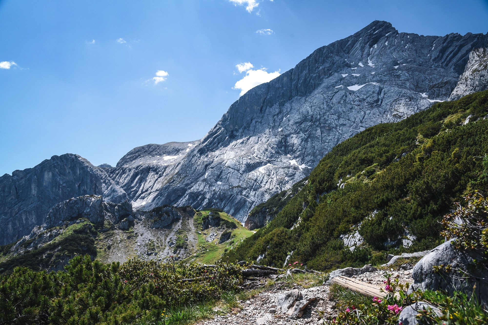 A bold rocky alpine peak under a blue sky