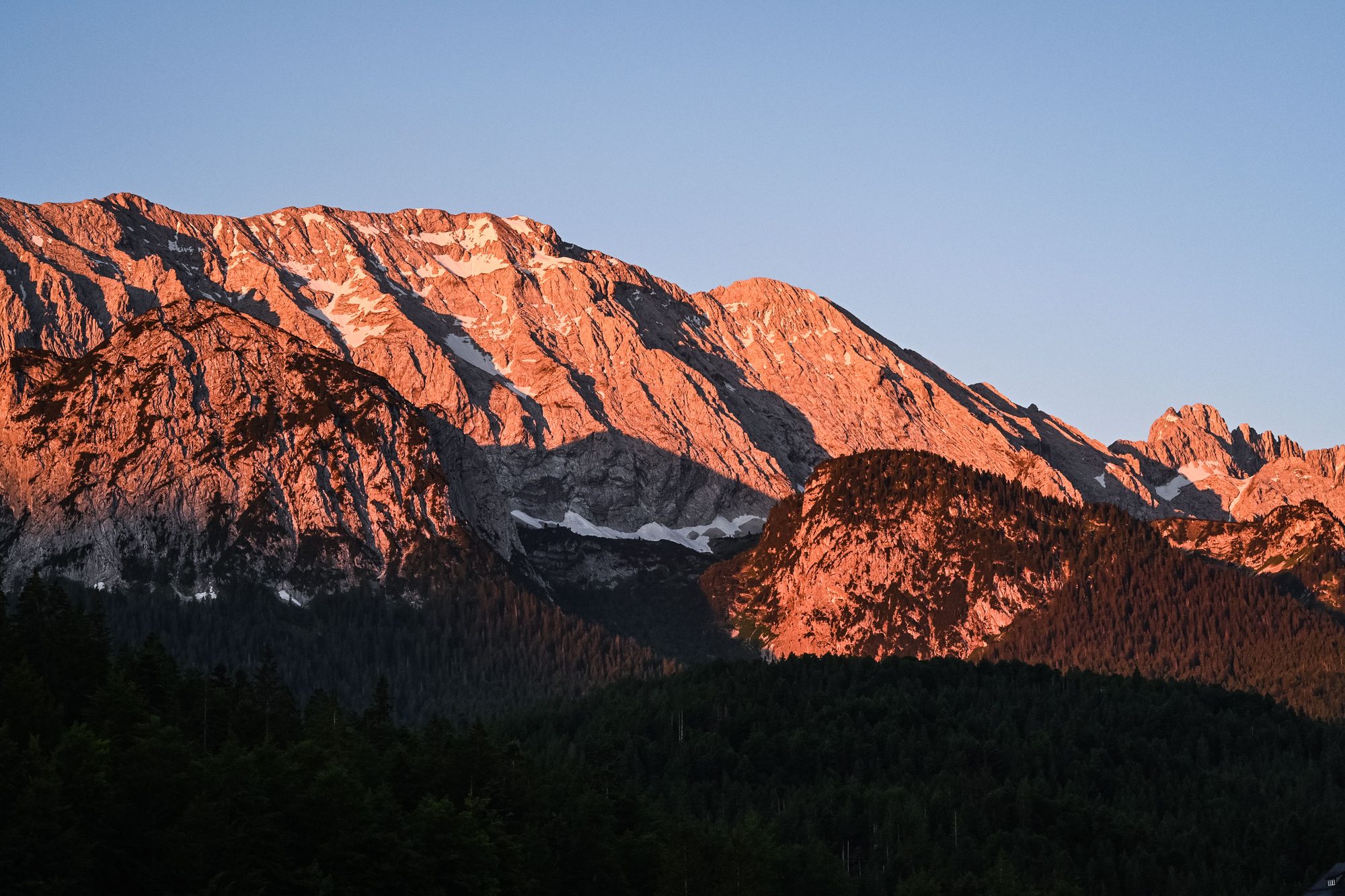 Golden sunrise over layered alpine ridges